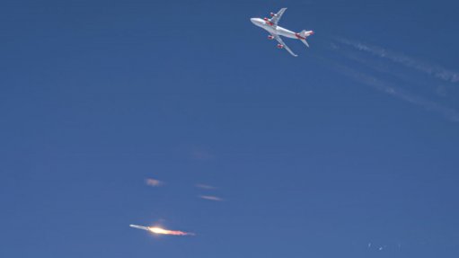 LauncherOne (bottom of picture) successfully ignites its first stage after being dropped by Boeing 747 “Cosmic Girl” (climbing away at the top of the picture)