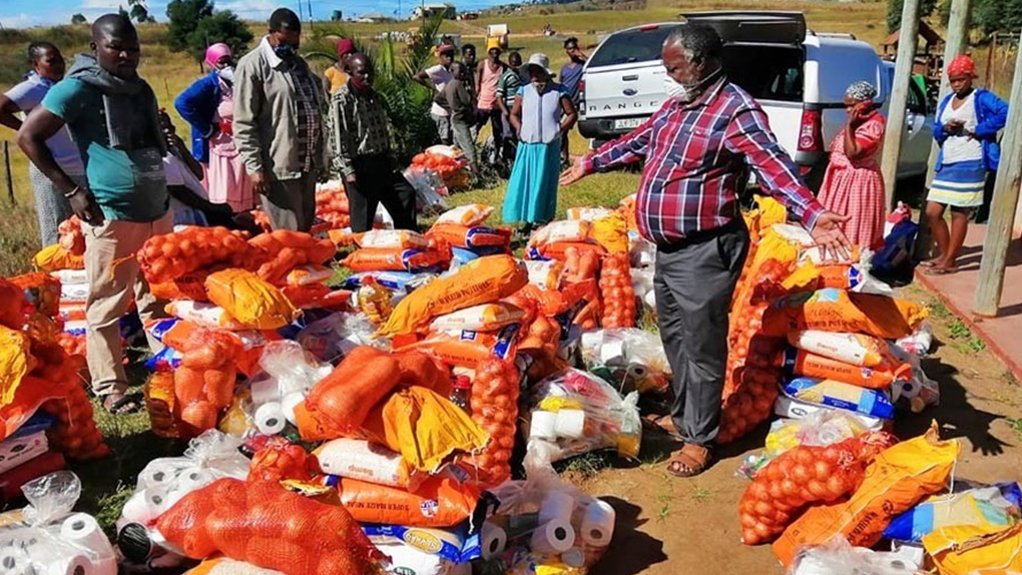 Rural communities on the South Coast receive food parcels donated by land restitution in Mathulini