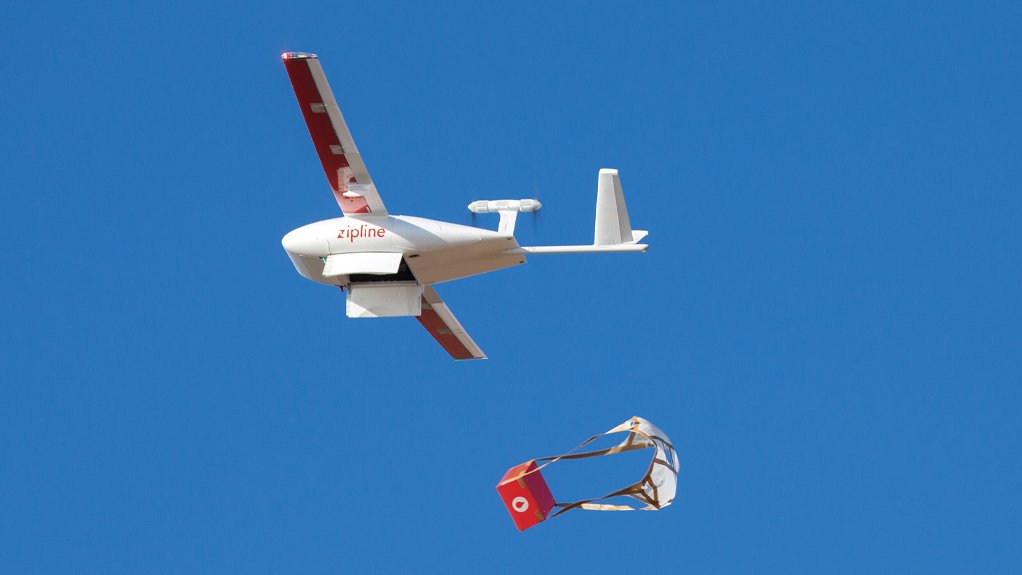 A Zipline fixed-wing drone drops a medical supply box