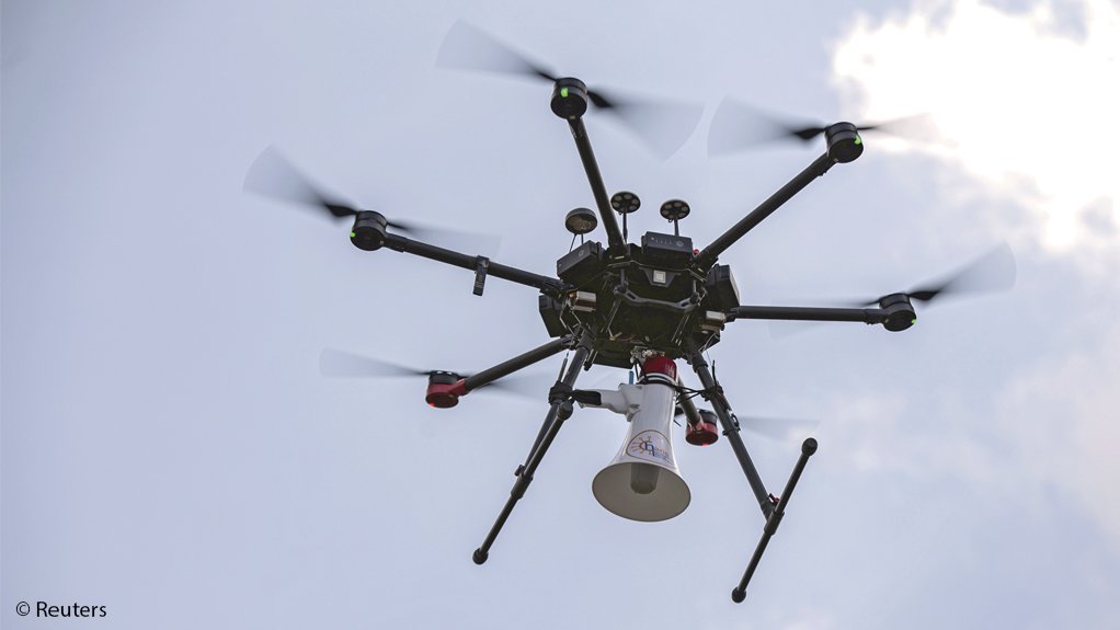 Authorities use a multi-rotor drone to broadcast messages through a loudspeaker in Kigali, Rwanda
