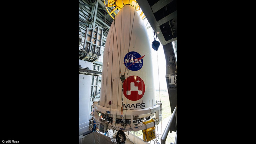 Encased within the nose cone, the Mars 2020 spacecraft is manoeuvred into place on top of its Atlas V launch rocket