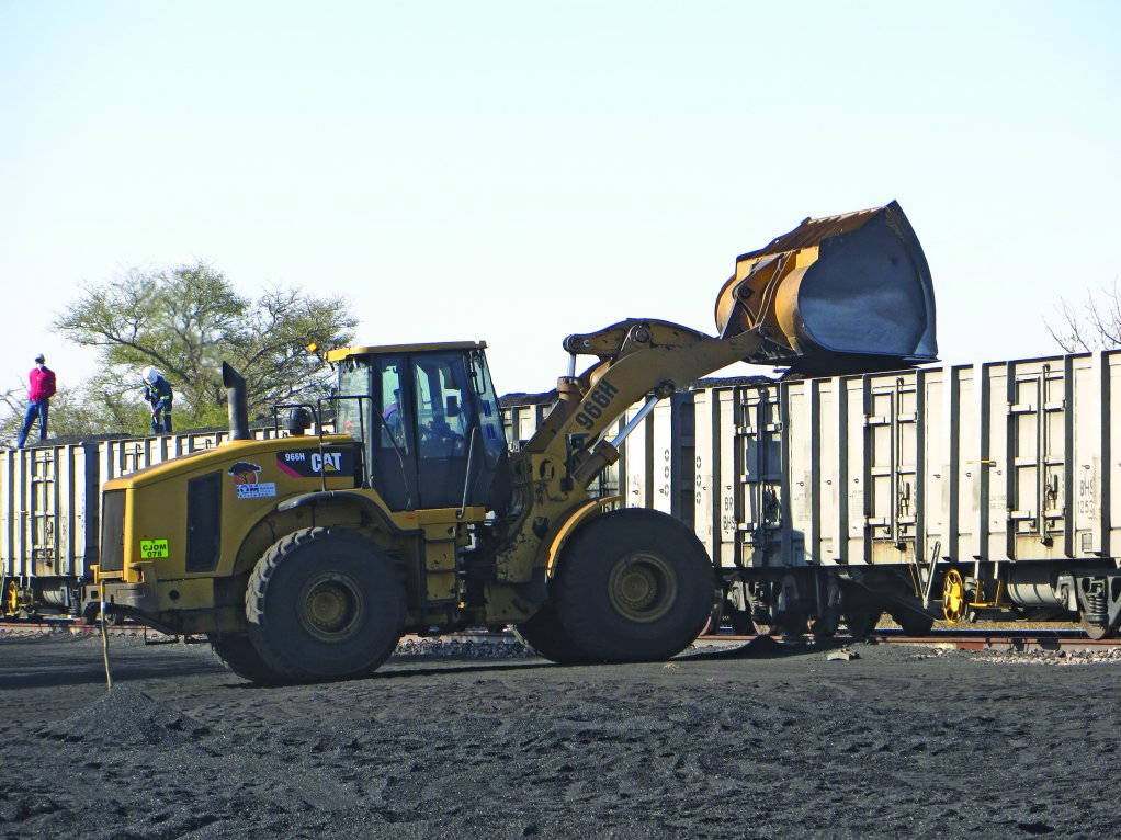 A wheel-loader loads Minergy's first coal export product into a Botswana Railways wagon en route to a South Africa client