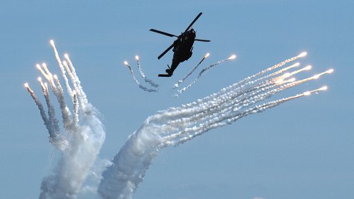A Swedish Air Force NH90 helicopter dispenses infrared countermeasure flares from a Saab Grintek Defence Integrated Defence Aids Suite