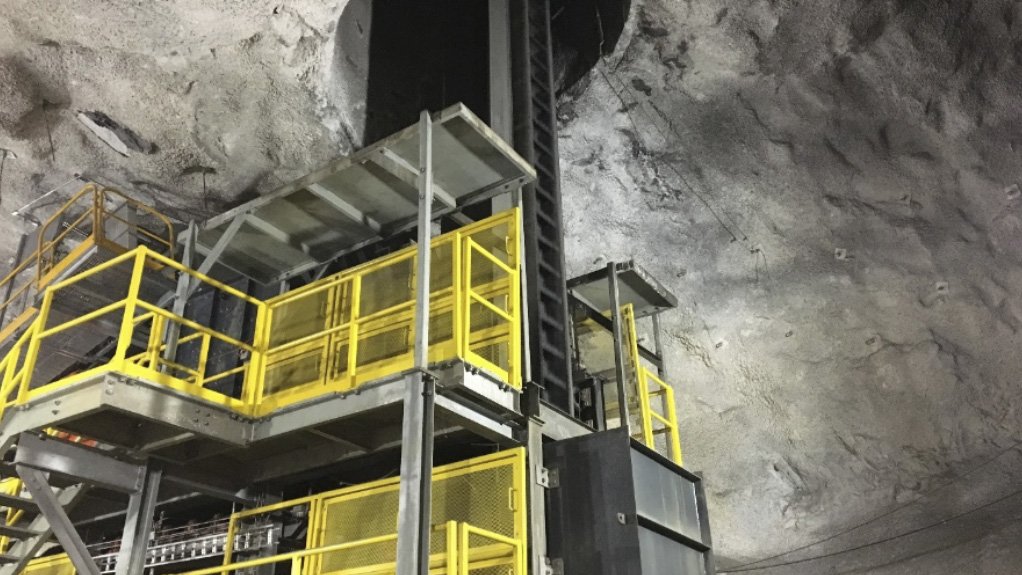 Underground loading station for a vertical conveyor