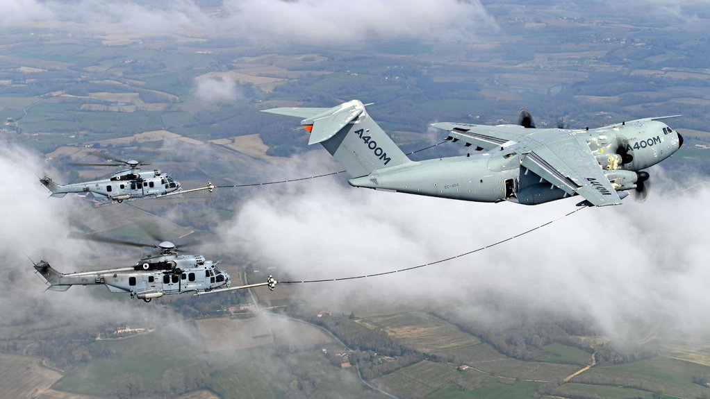 An Airbus A400M refueling two French Air Force H225M helicopters mid-air