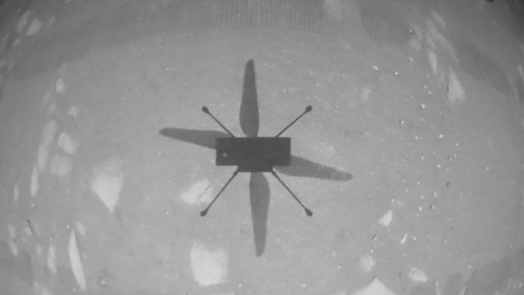 A monochrome photo taken by Ingenuity's navigation camera showing the shadow of the helicopter as it hovered over the Martian surface.
