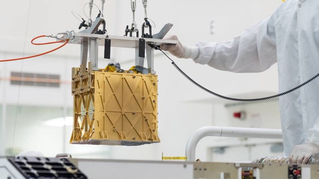 The Moxie instrument is lowered into its place in the Perseverance lander, during the latter’s final assembly.