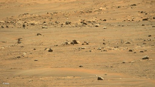 Ingenuity (far left) photographed at its new landing site by the Perseverance rover