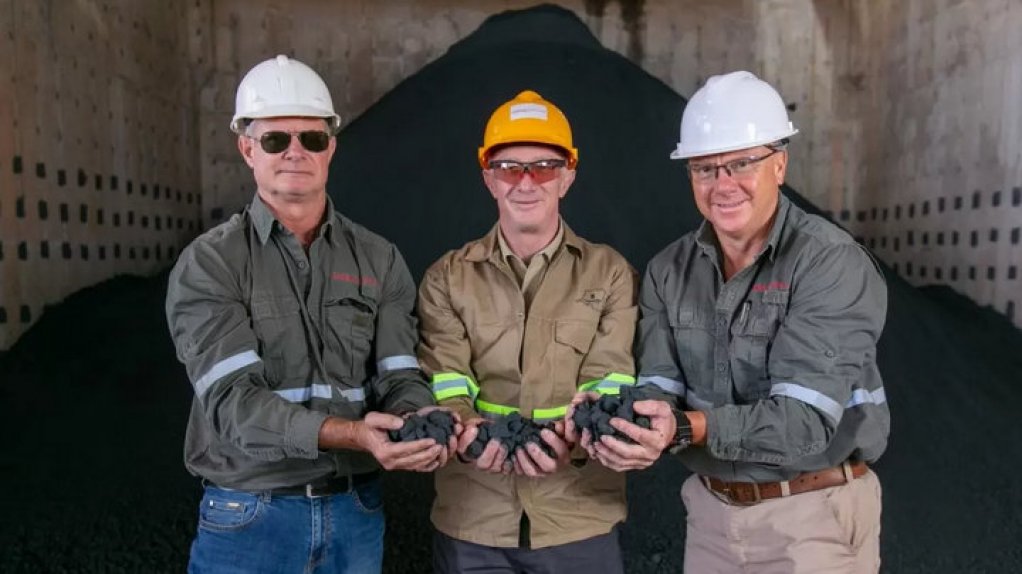 Kamoa Copper CEO Mark Farren, Kamoa Copper head of projects Steve Amos and risk control manager Wimpie Steyn holding some of Kamoa Copper's first copper concentrate.