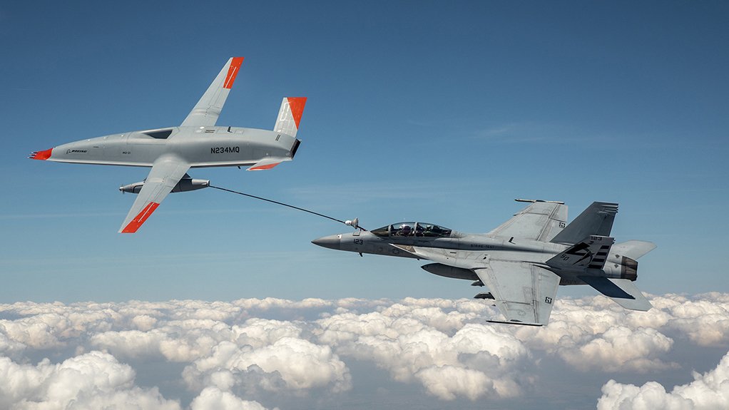 The MQ-25 (left) refuels the Super Hornet.