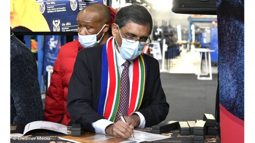Trade, Industry and Competition Minister Ebrahim Patel signs the Steel Master Plan as Numsa's Irvin Jim prepares to do likewise