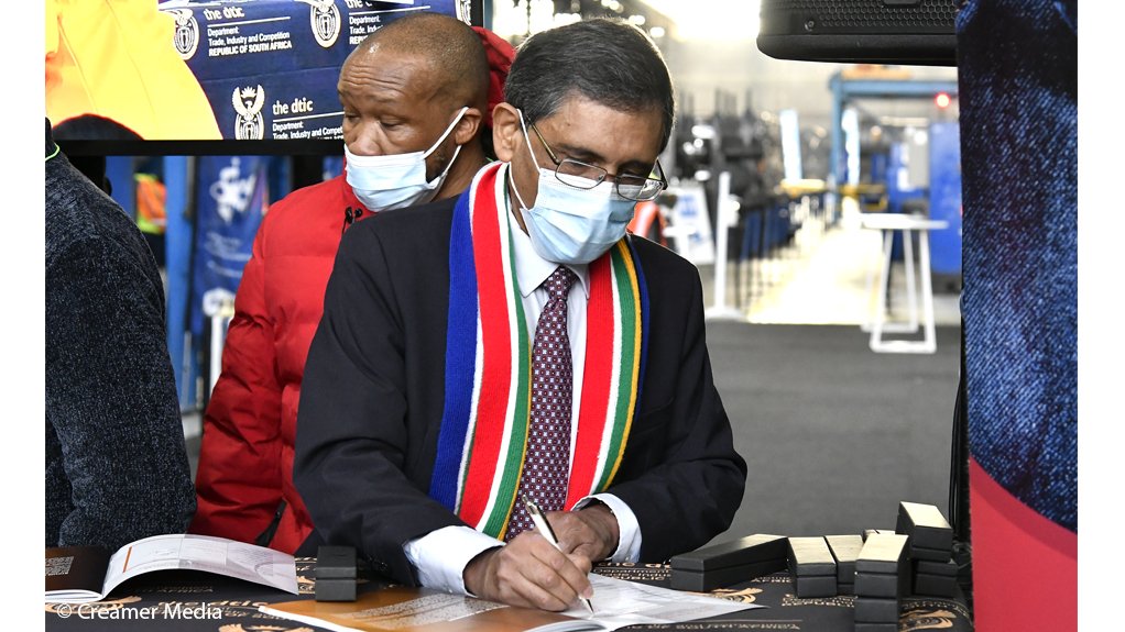 PUTTING PEN TO PAPER Trade, Industry and Competition Minister Ebrahim Patel signs the Steel Master Plan as Numsa's Irvin Jim prepares to do likewise