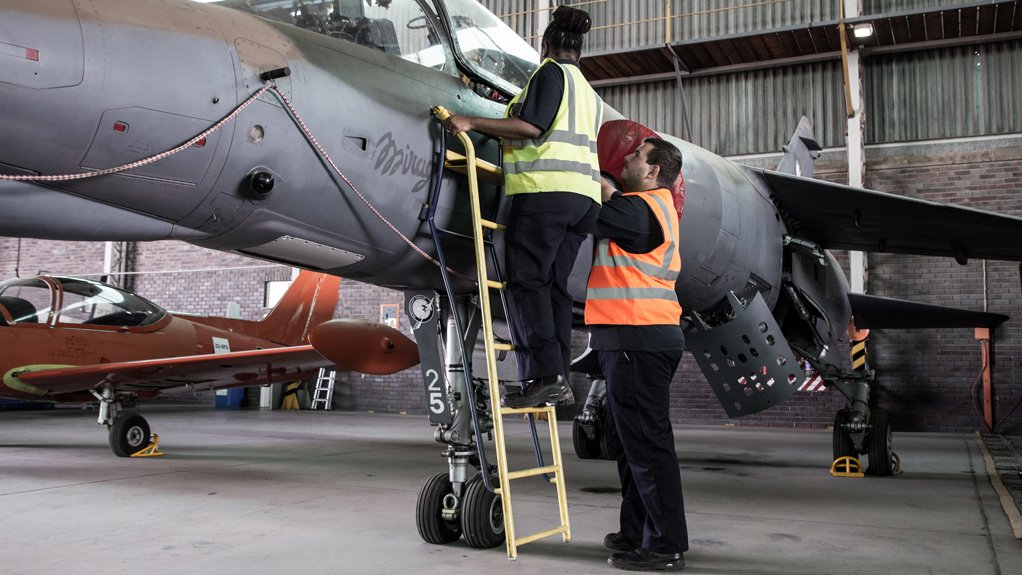 A aviation technical student examines one of Paramount's Dassault Mirage jets