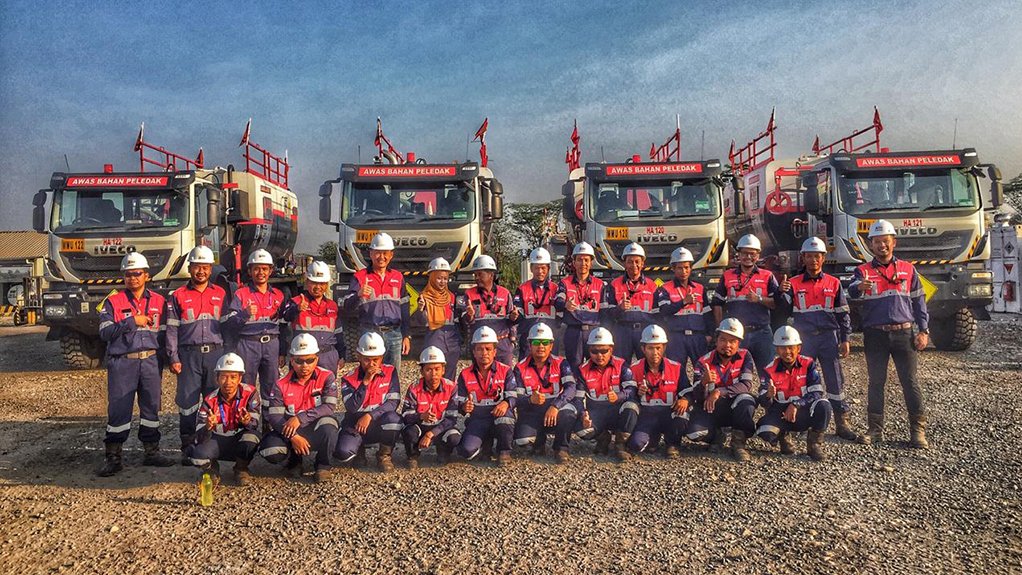 An image/photo of BME Indonesia staff and trucks