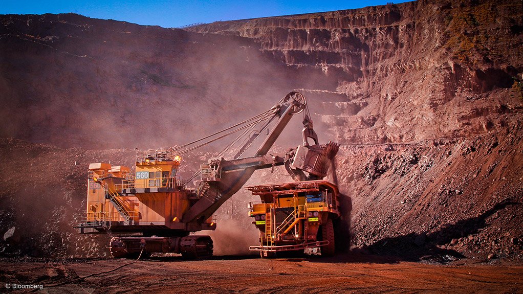 Image of large mining vehicles at an iron-ore mine