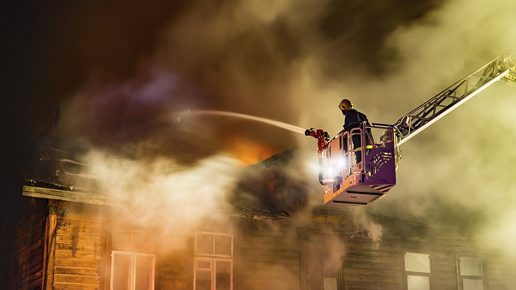 Image of a firefighter on firetruck boom extension