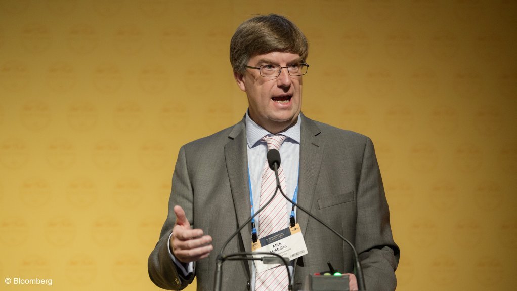 Photo of a man, Mick McMullen, speaking at a function.