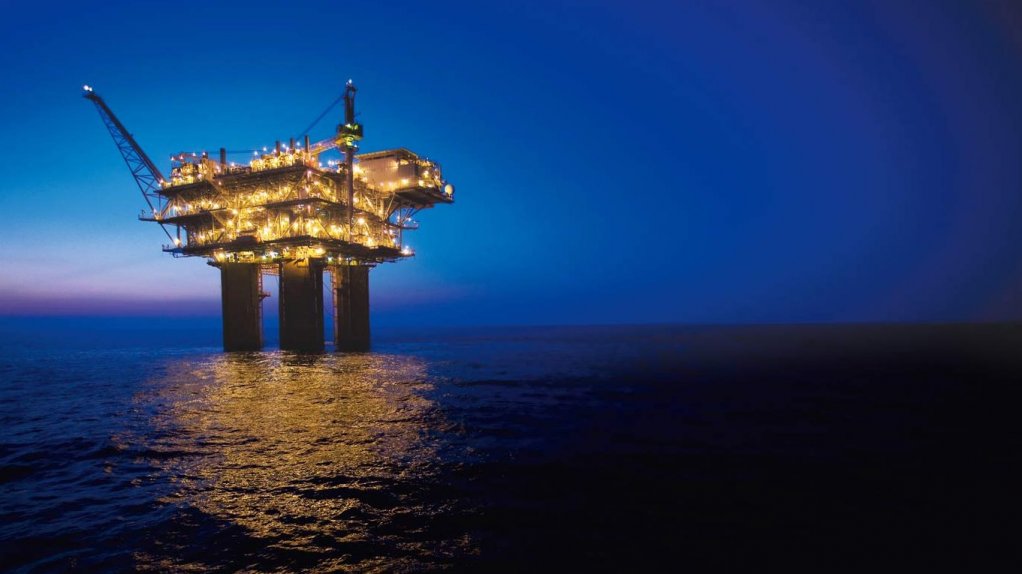 An image showing an oil rig at night