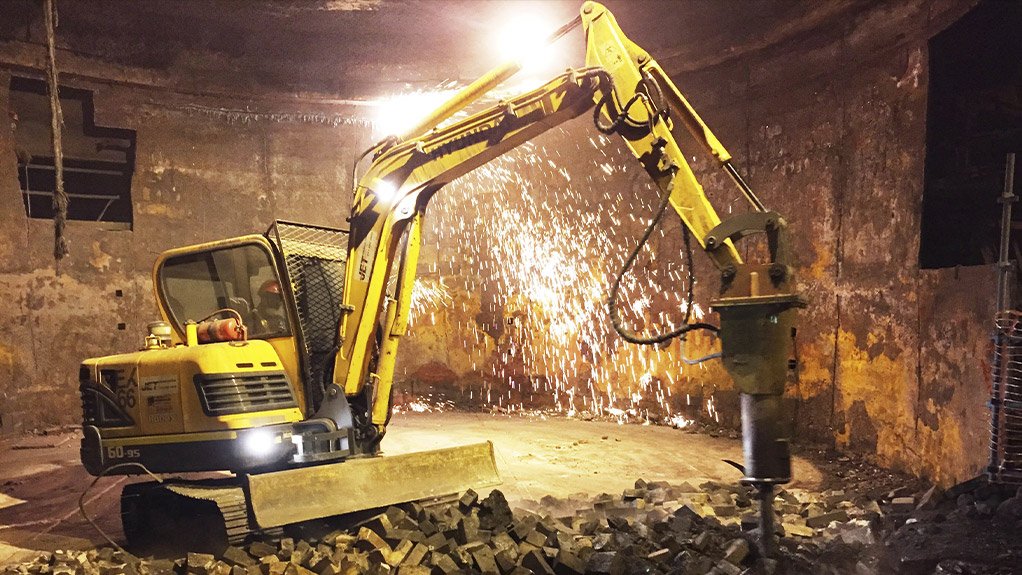 Mini excavator undertaking refractory demolition in a furnace 