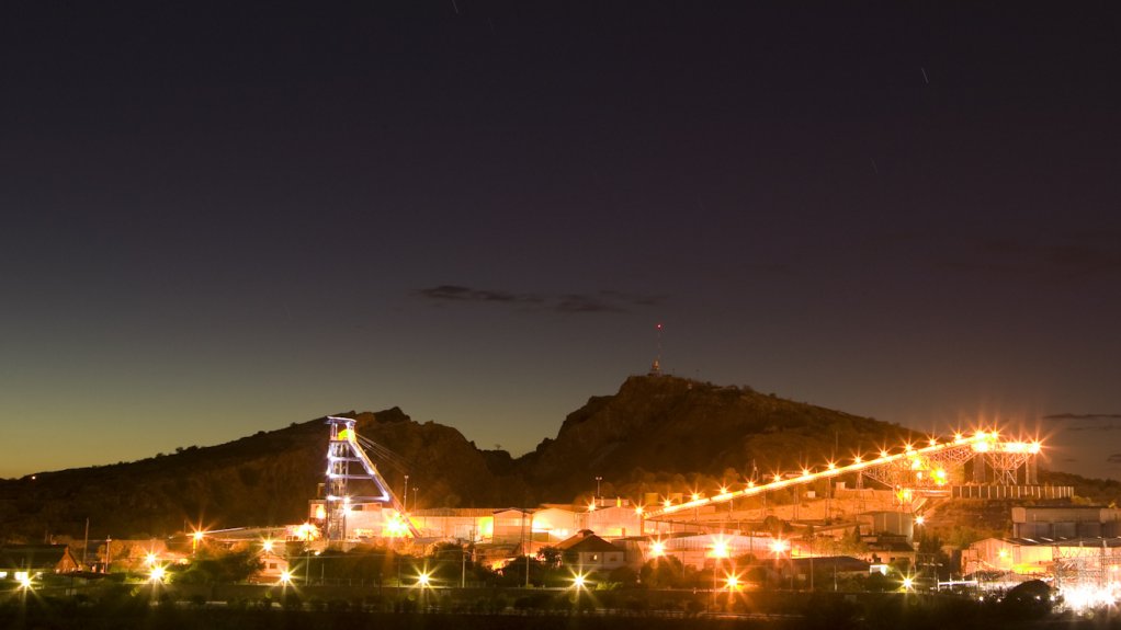 An image of a mine processing facility at night.