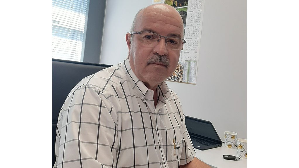 Rosond Director Carlos Da Silva sat at a desk discusses Platinum Group Metals