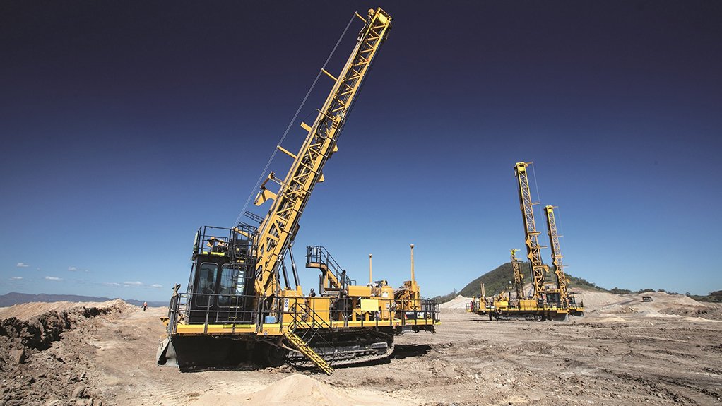 A photo of two Cat MD6310 rotary blasthole drills