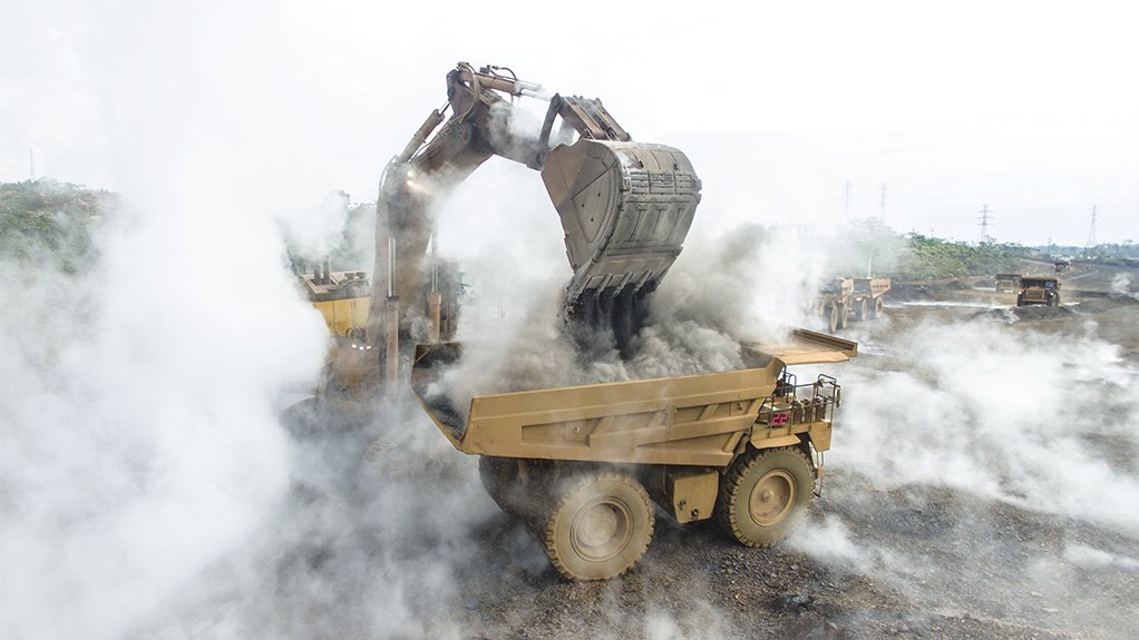 Picture of an excavator loading rubble into a dumb truck