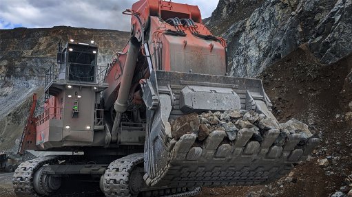 An image of a large red tracked front loader at the mine face with bucket full of ore ready to be graded by a ShovelSense system 