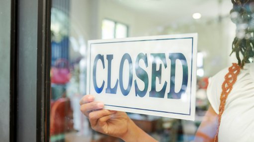 Pic/Image of Closed for Business Sign in Shop Storefront.