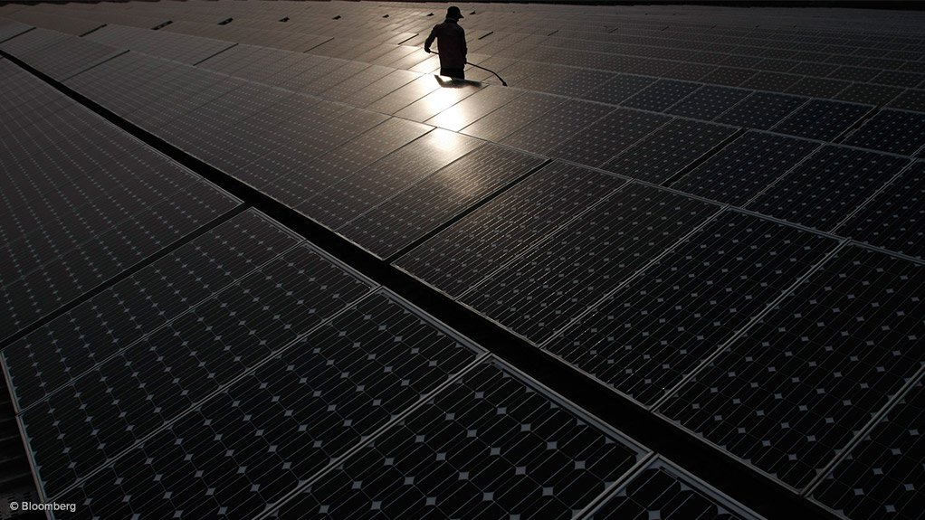 An image showing solar panels being cleaned at a power station in New Delhi 