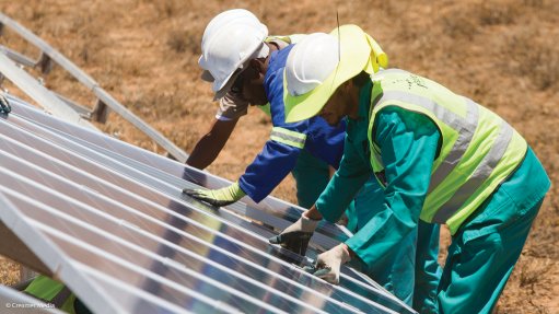 Photo of workers installing solar panels at a project in South Africa