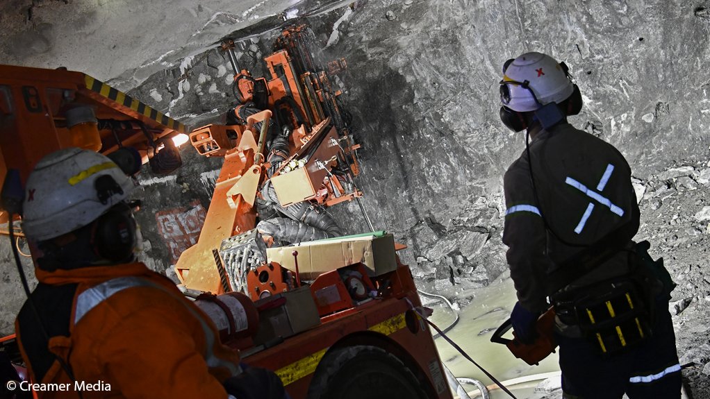 a picture of miners at the Booysendal South mine work on constructing a new decline shaft