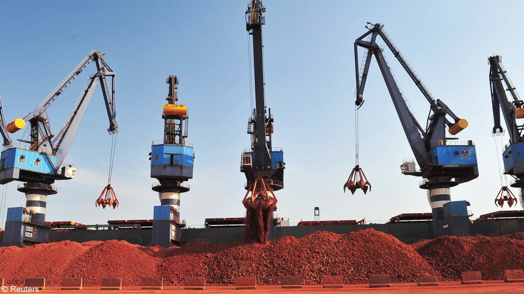 A ship carrying bauxite from Guinea is unloaded at a port.