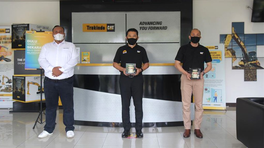 Three representative of Metso Outotec and PT Trakindo Utama standing in a Trakindo reception area