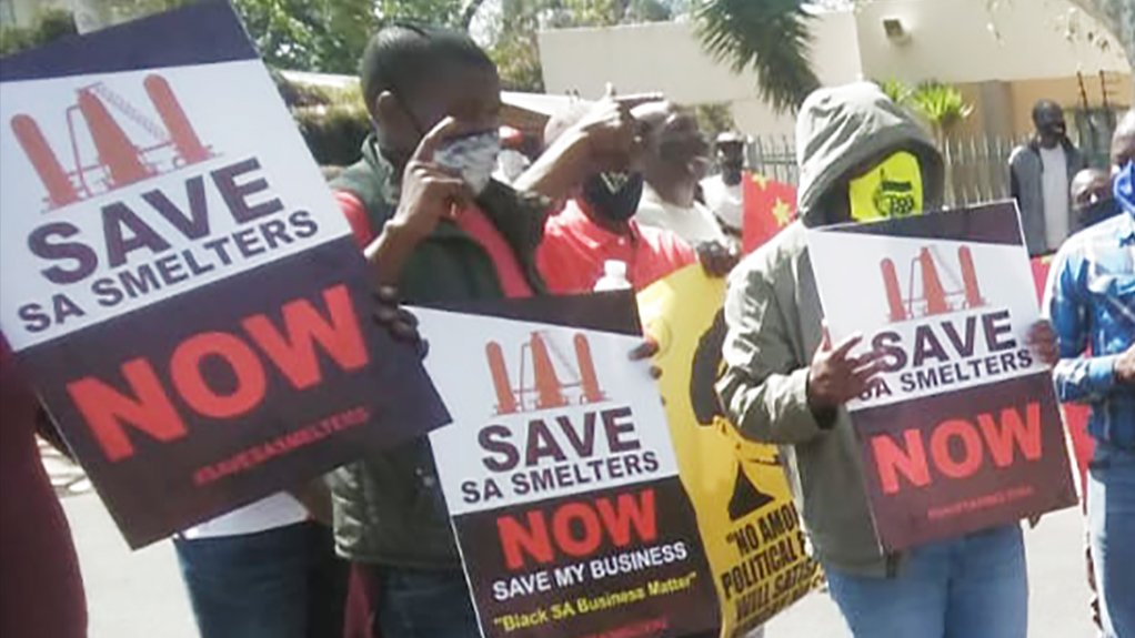 Picture of protestors holding Save SA Smelters placards