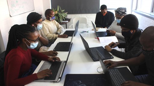 Image of people on computers, illustrating a new artificial intelligence platform has been unveiled by Telkom, in collaboration with Enlabeler