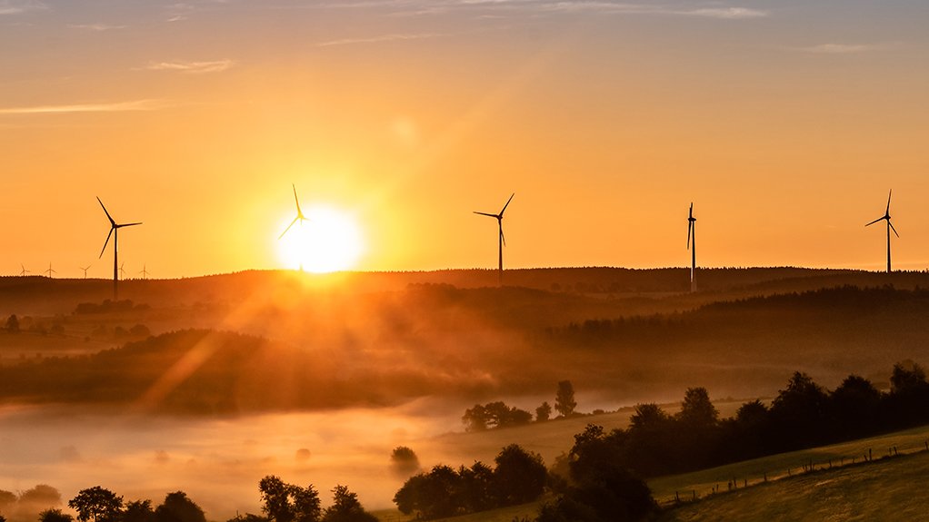 Image of a sunset and wind turbines 