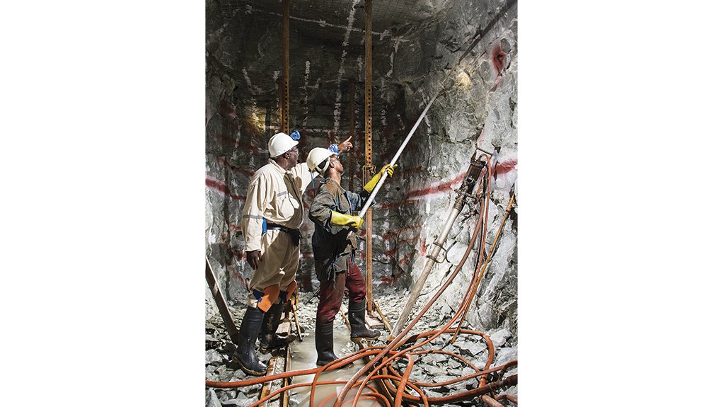 An image of miners working in a deep level mine