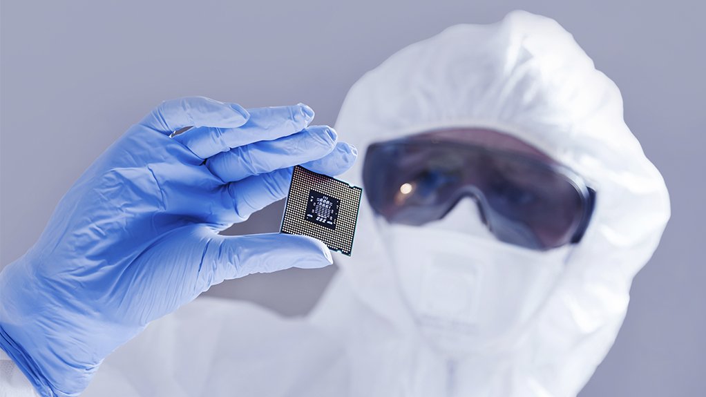 Image of a man holding a computer chip