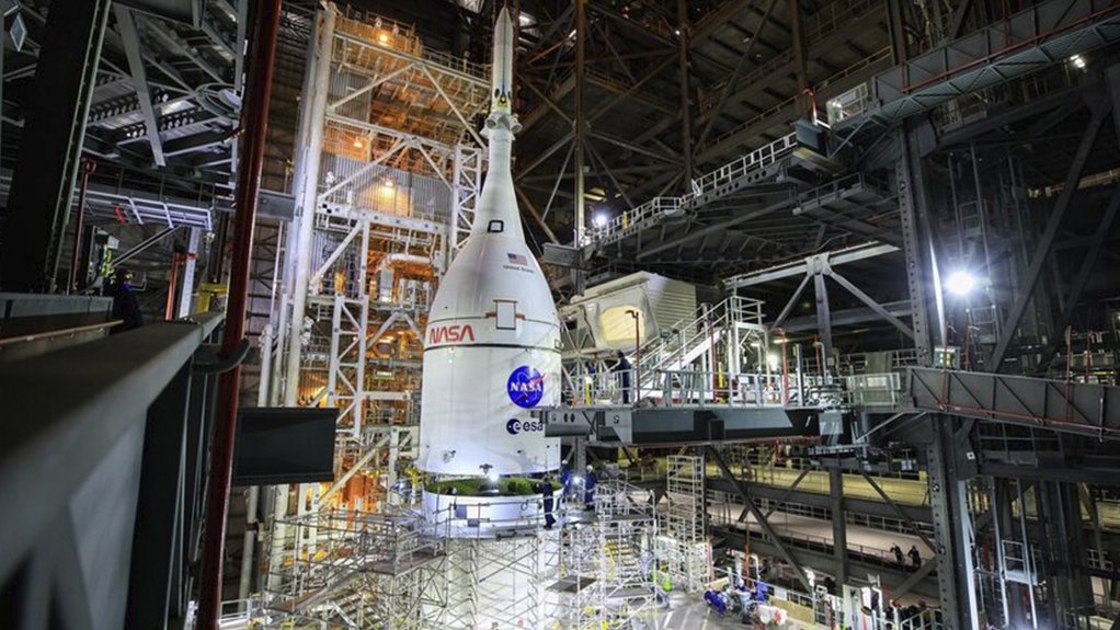 A photo of the Orion spacecraft mounted on top of the SLS in the VAB