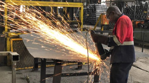 A man welding a steel mes screen used in the copper mines as a support underground, at the Afrope manufacturing plant in Zambia