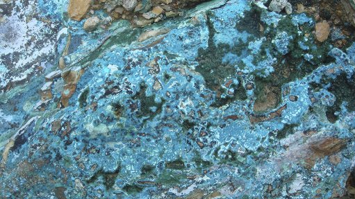 Chrysocolla and malachite exposures on a rock face in Zambia both are copper ores