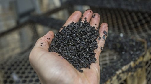 Picture of a hand holding pieces of iron ore