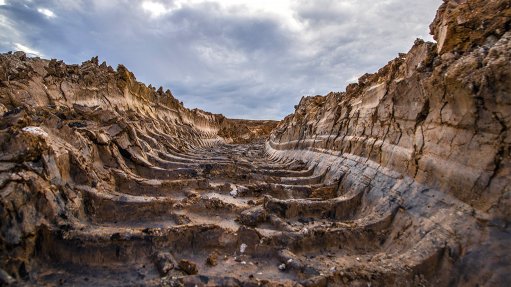 A photo of a track in the mud of a colliery left by a large mining machine