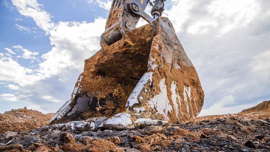 A photo of an excavator’s bucket resting on the ground in a colliery