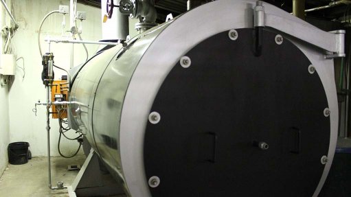 A large gas fueled boiler inside a building used in industrial applications