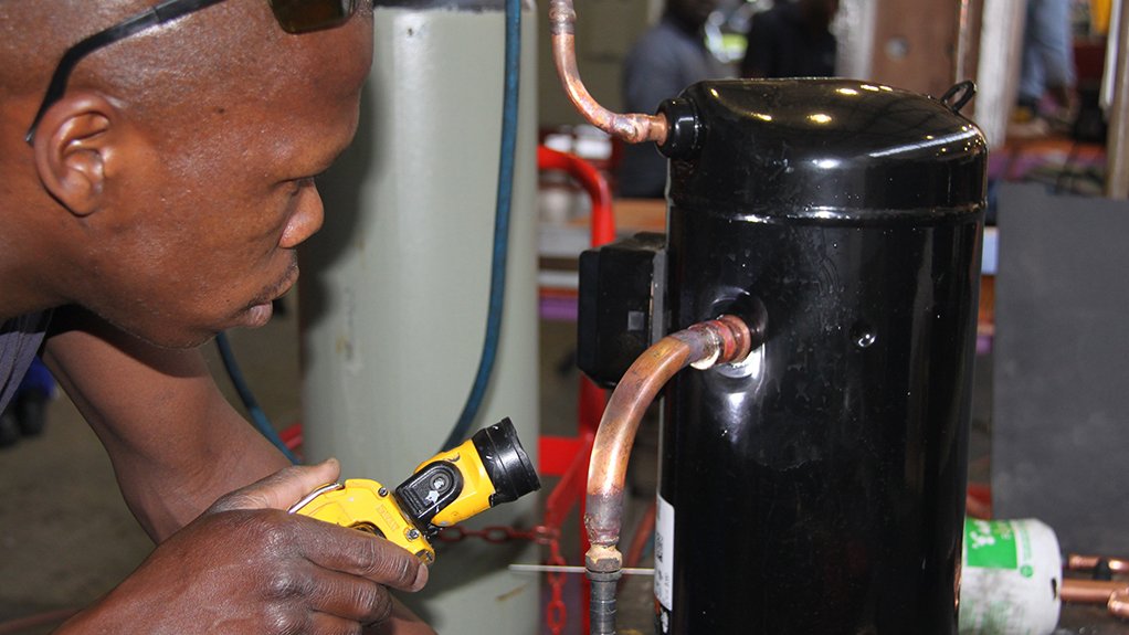 Image of a Booyco Engineering technician inspecting a compressor joint