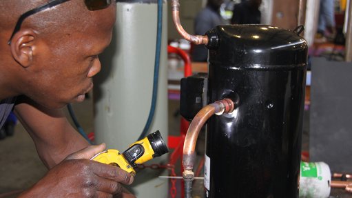 Image of a Booyco Engineering technician inspecting a compressor joint