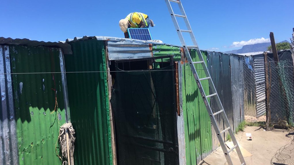 Solar power panel being looked at in Freedom Farm informal settlement.