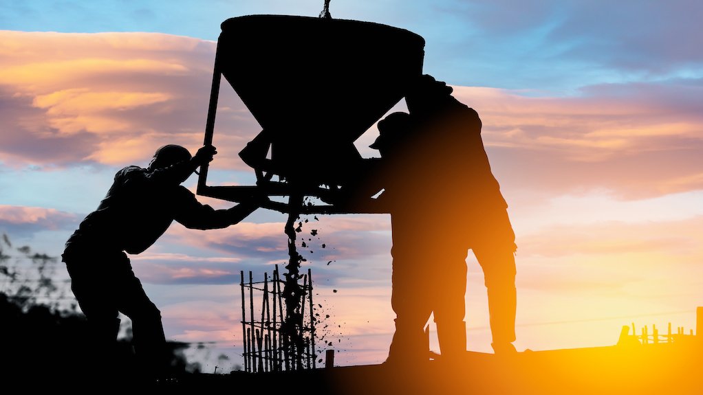 Image of construction workers at dusk